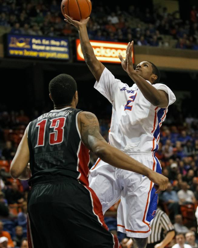 Boise State's Derrick Marks, right, goes for a layup over UNLV's Bryce Dejean-Jones (13) during the first half of an NCAA college basketball game in Boise, Idaho, Saturday, Feb. 22, 2014. Boise State won 91-90 in overtime. (AP Photo/Otto Kitsinger)